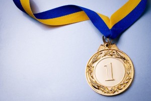 depositphotos_61836533-stock-photo-gold-medal-on-blue